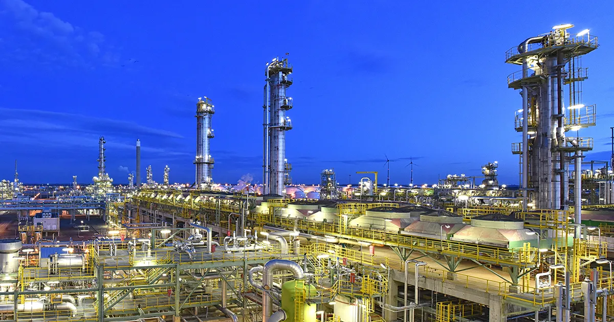 Exterior view of a chemical plant and petroleum refinery at dusk, an industry utilizing Syn-Fab Inc. camera systems