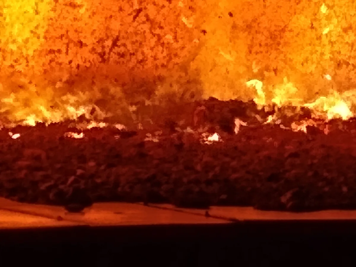 Inside view of a high-temperature industrial power boiler furnace showing combustion and ash pit diagnostics captured by a Syn-Fab camera system.